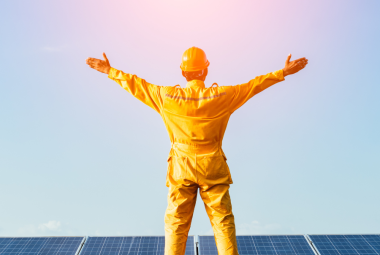 Image of an installer standing on solar panels after installation is complete.